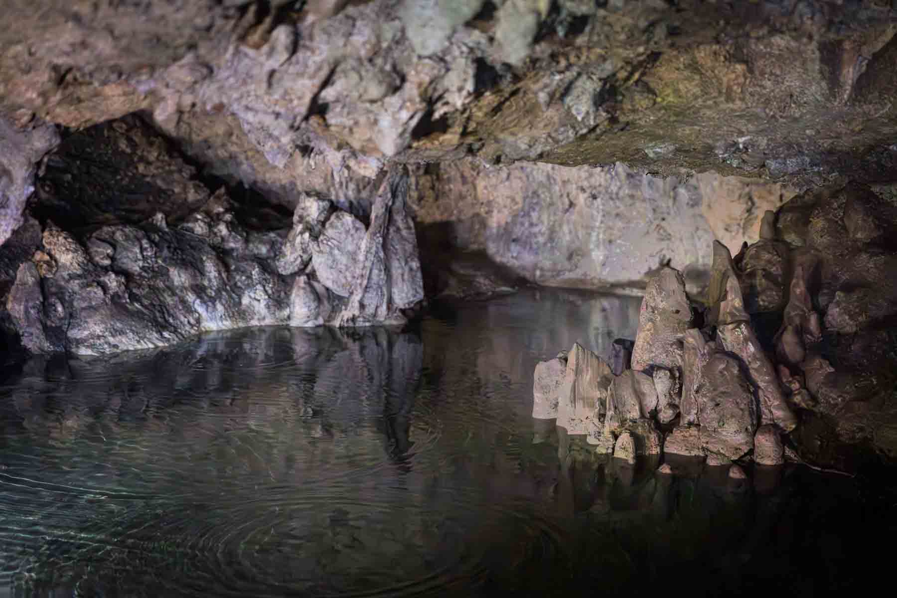 Rock formations and body of water in Cascade Caverns for an article entitled, ‘Visiting Boerne, Texas: Everything You Need to Know’