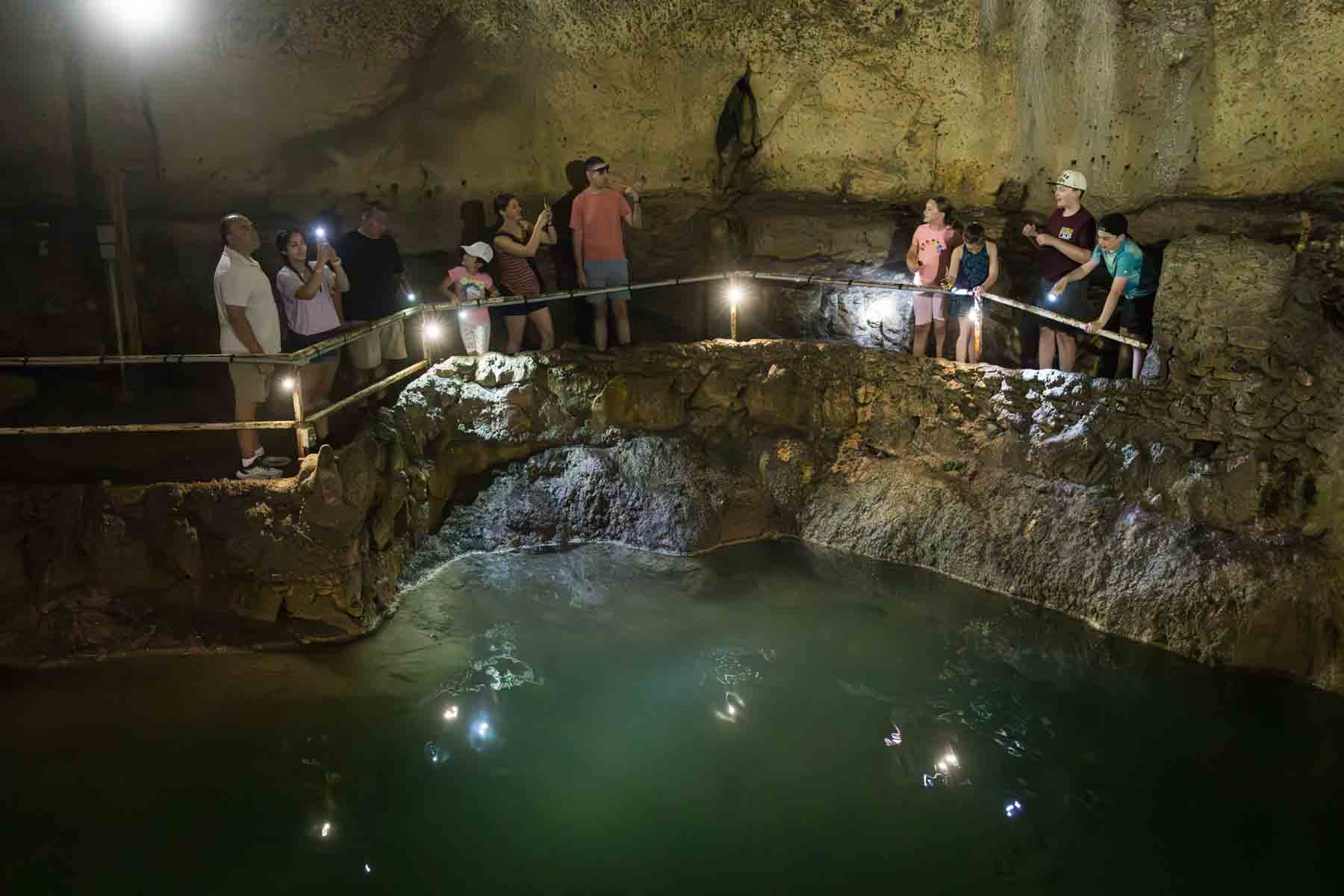 Guests standing over water in Cathedral Room in Cascade Caverns for an article entitled, ‘Visiting Boerne, Texas: Everything You Need to Know’