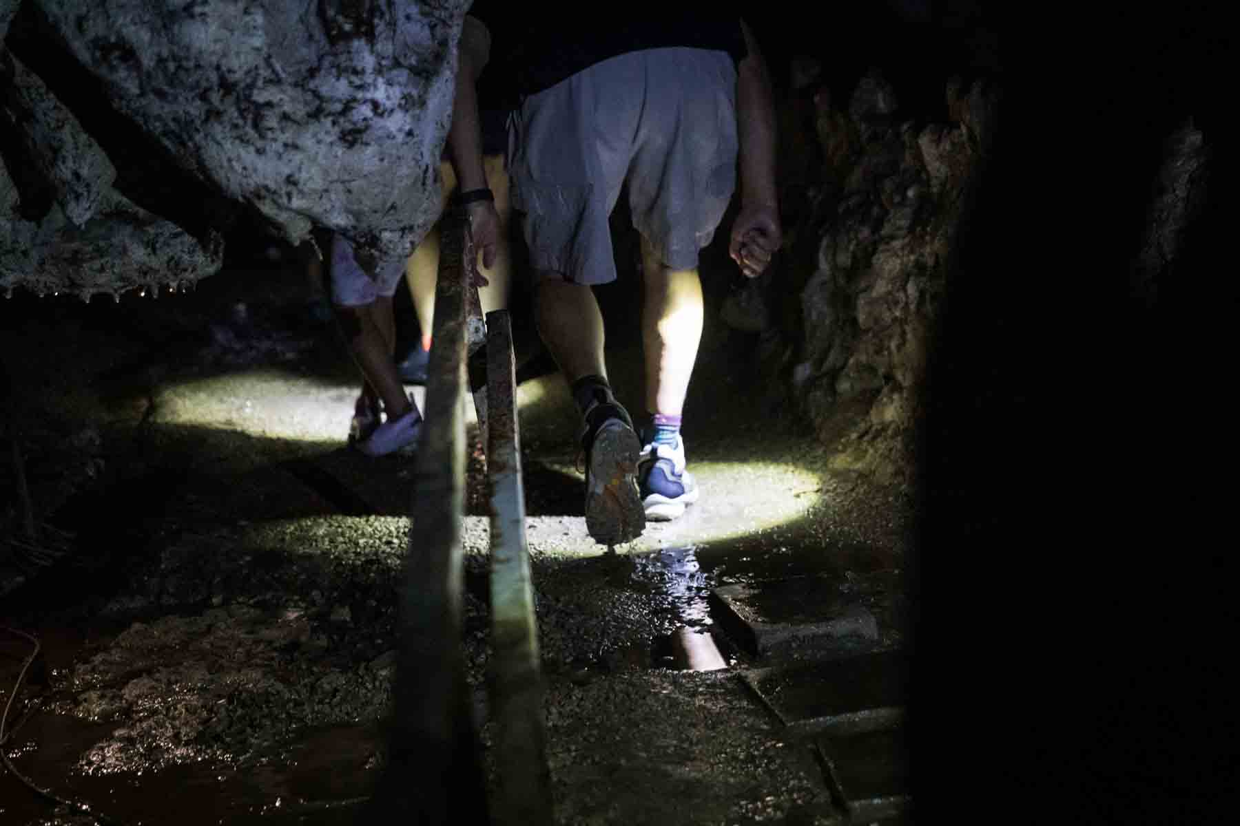 Close up of visitor's feet walking through Cascade Caverns for an article entitled, ‘Visiting Boerne, Texas: Everything You Need to Know’