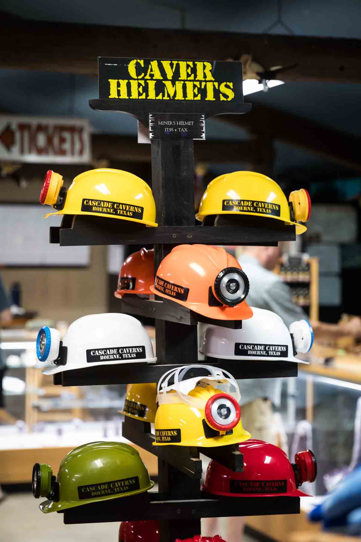 Children's caving helmets for sale at Cascade Caverns gift shop for an article entitled, ‘Visiting Boerne, Texas: Everything You Need to Know’