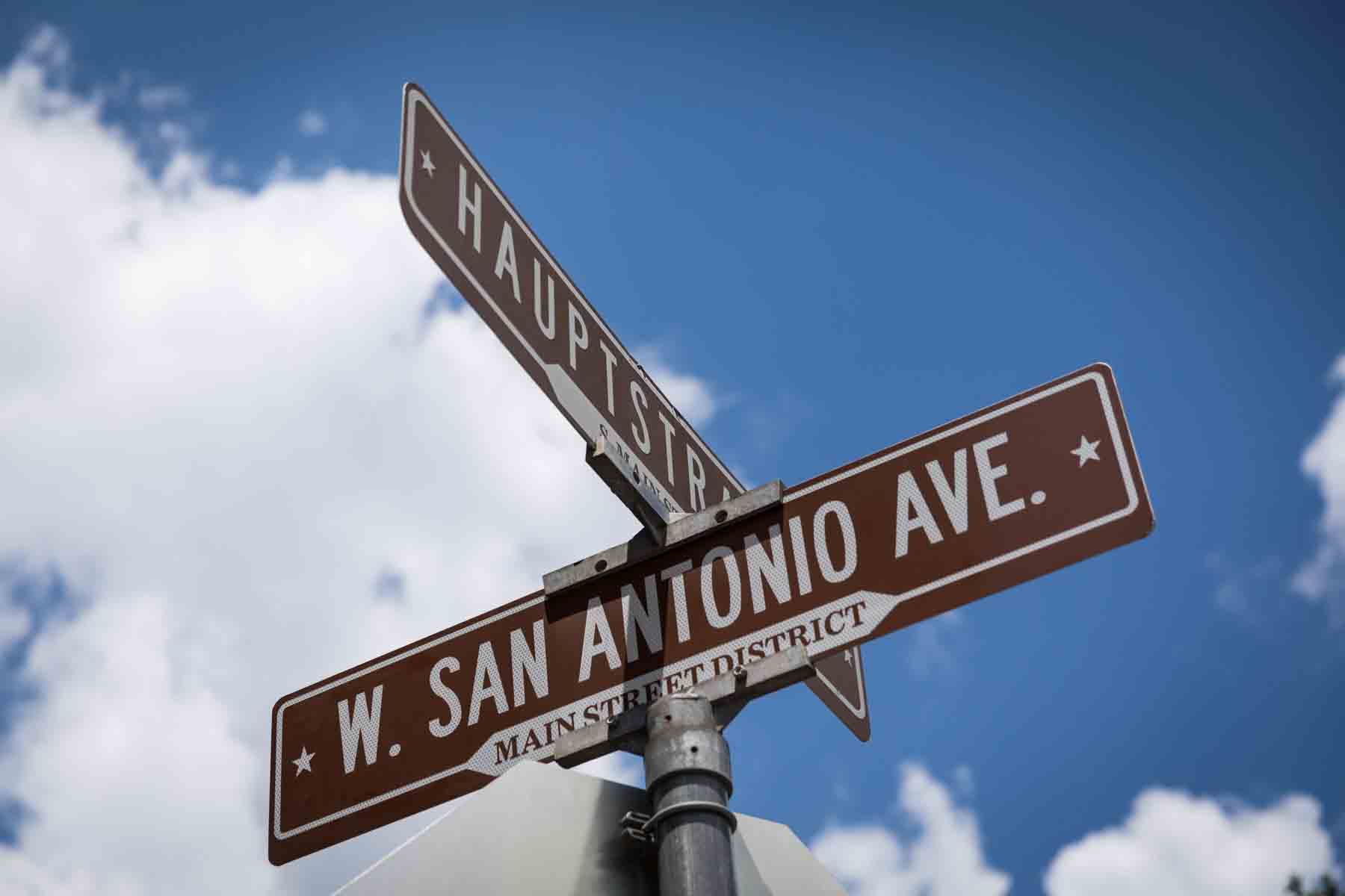 Street sign against sky with clouds for an article entitled, ‘Visiting Boerne, Texas: Everything You Need to Know’