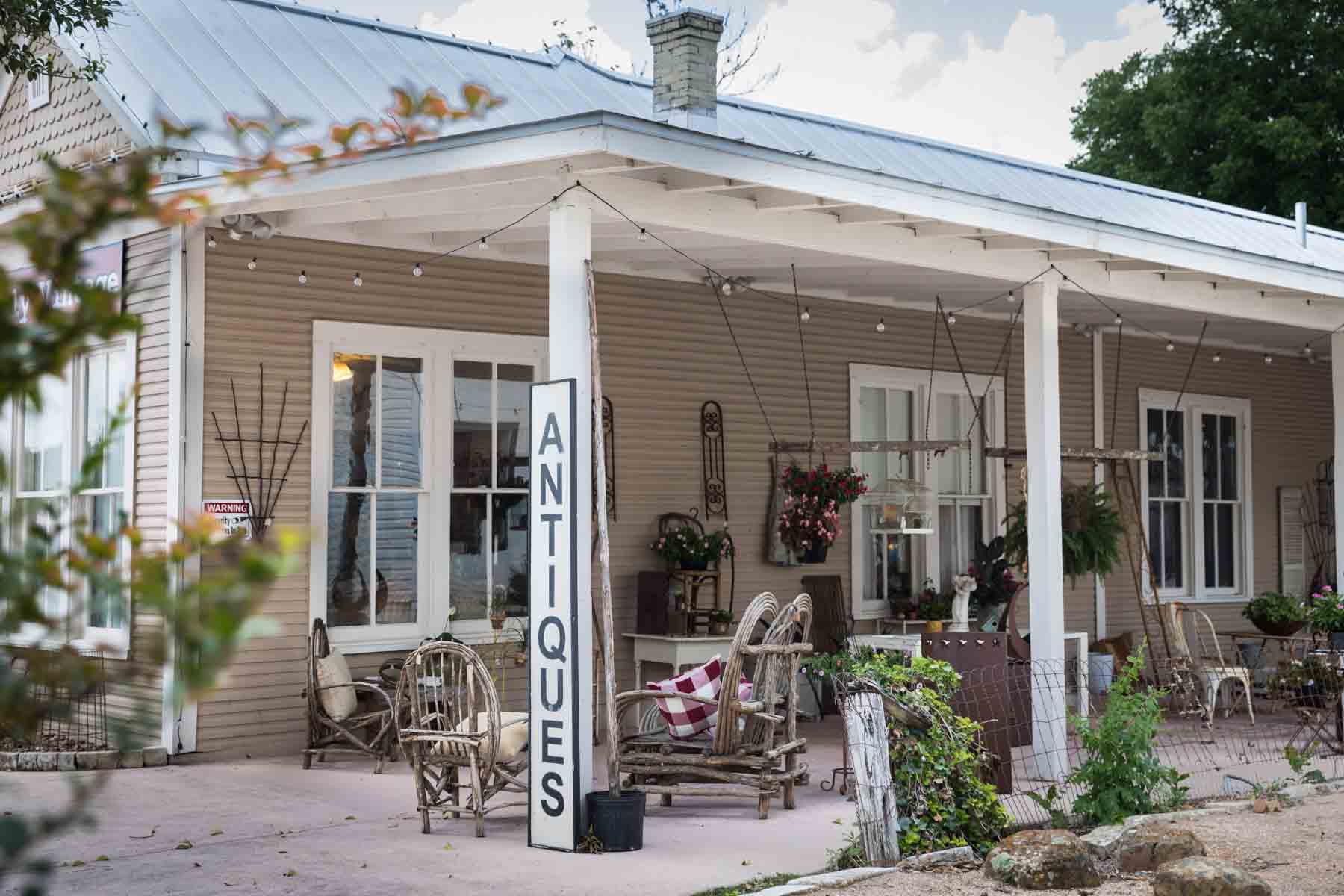 Antiques store with large porch and antiques sign for an article entitled, ‘Visiting Boerne, Texas: Everything You Need to Know’