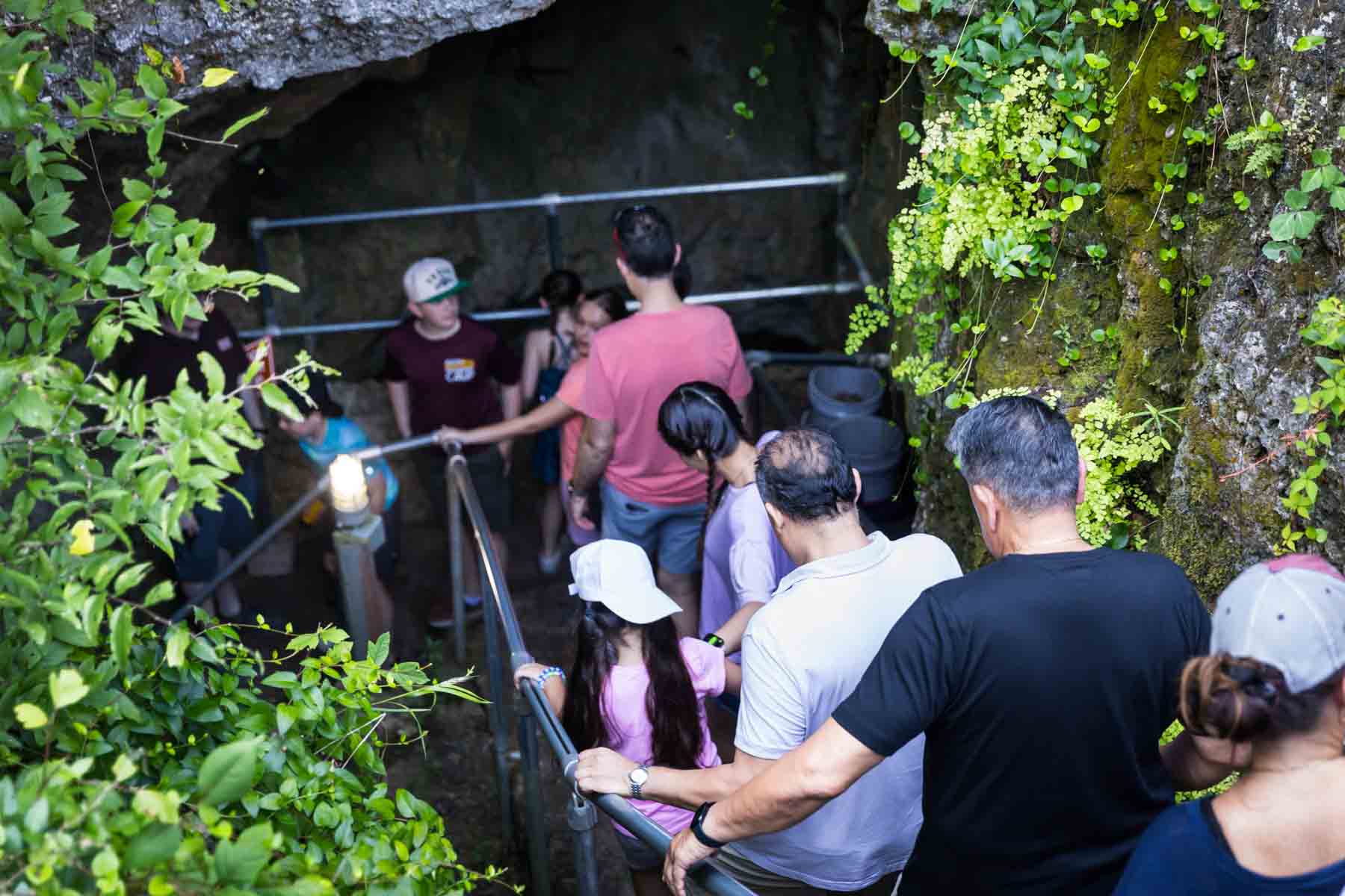 Visitors walking down staircase in Cascade Caverns for an article entitled, ‘Visiting Boerne, Texas: Everything You Need to Know’