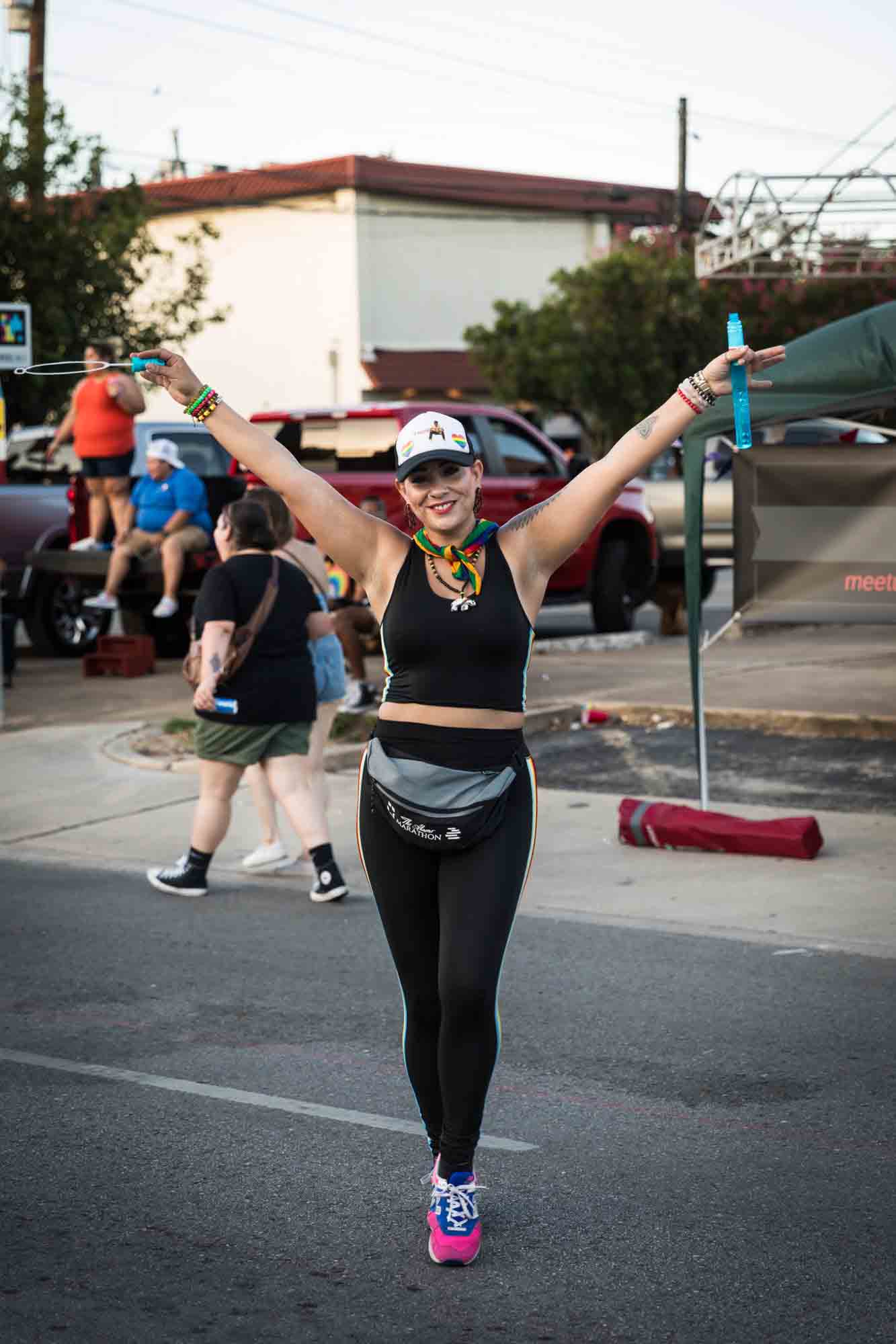 San Antonio gay pride parade photos of woman joyously holding arms above head