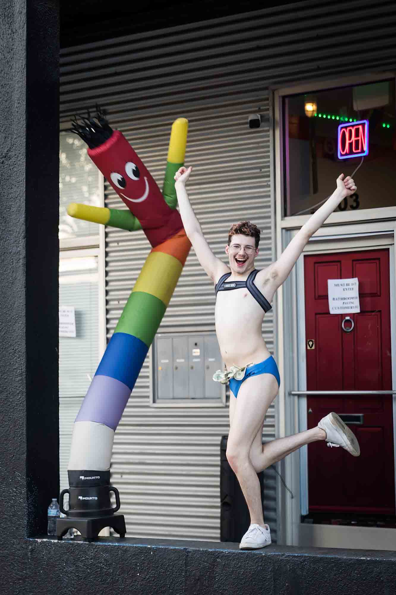 San Antonio gay pride parade photos of go go dancing boy dancing beside rainbow air puppet