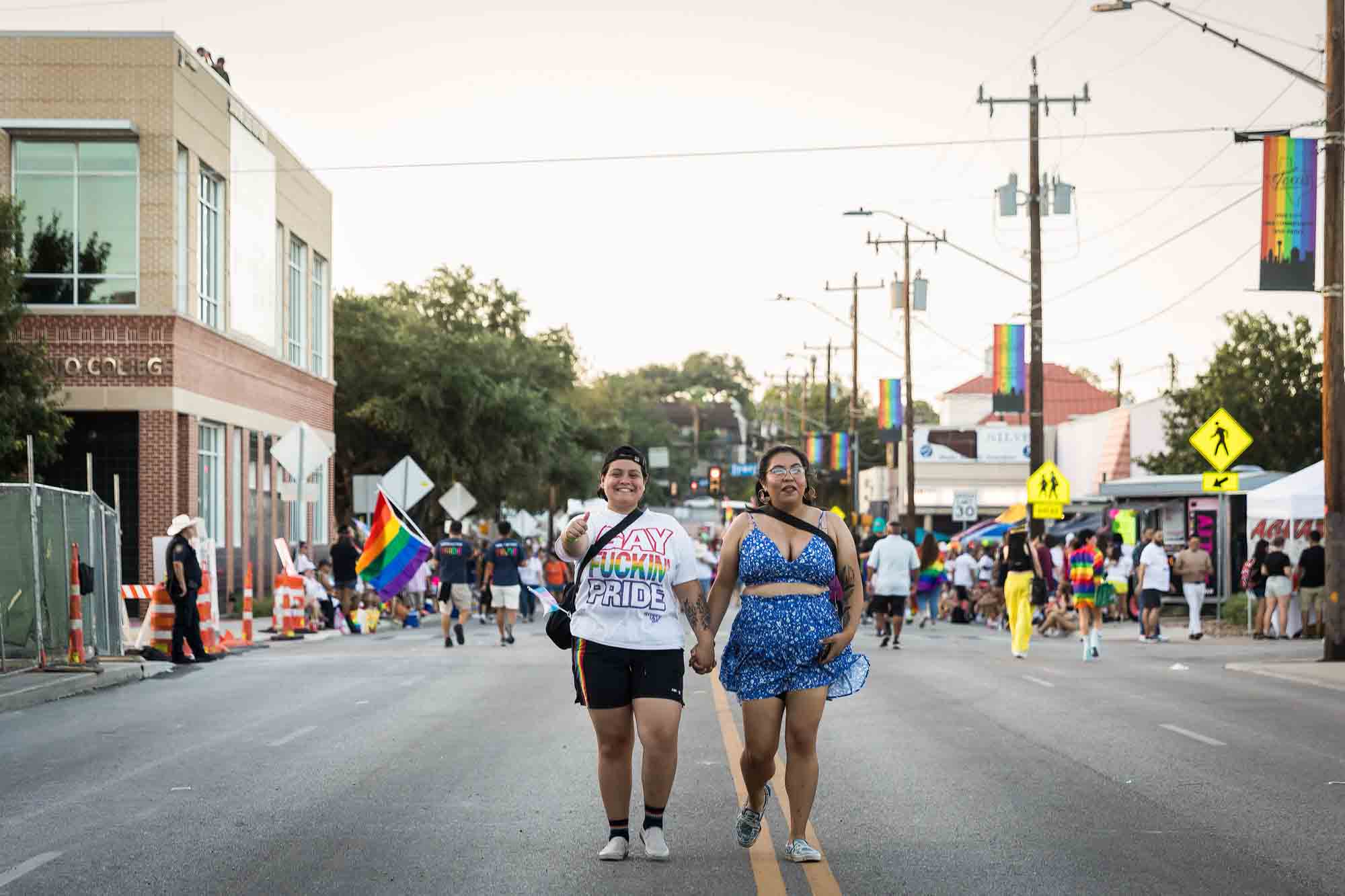 San Antonio gay pride parade photos of lesbian couple holding hands in middle of road