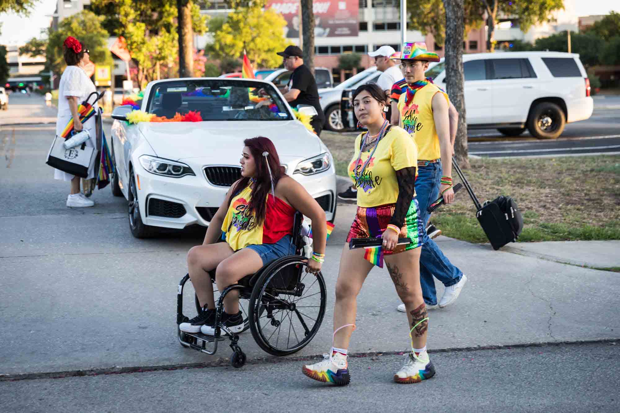 San Antonio gay pride parade photos of woman in wheelchair and other people wearing yellow shirts