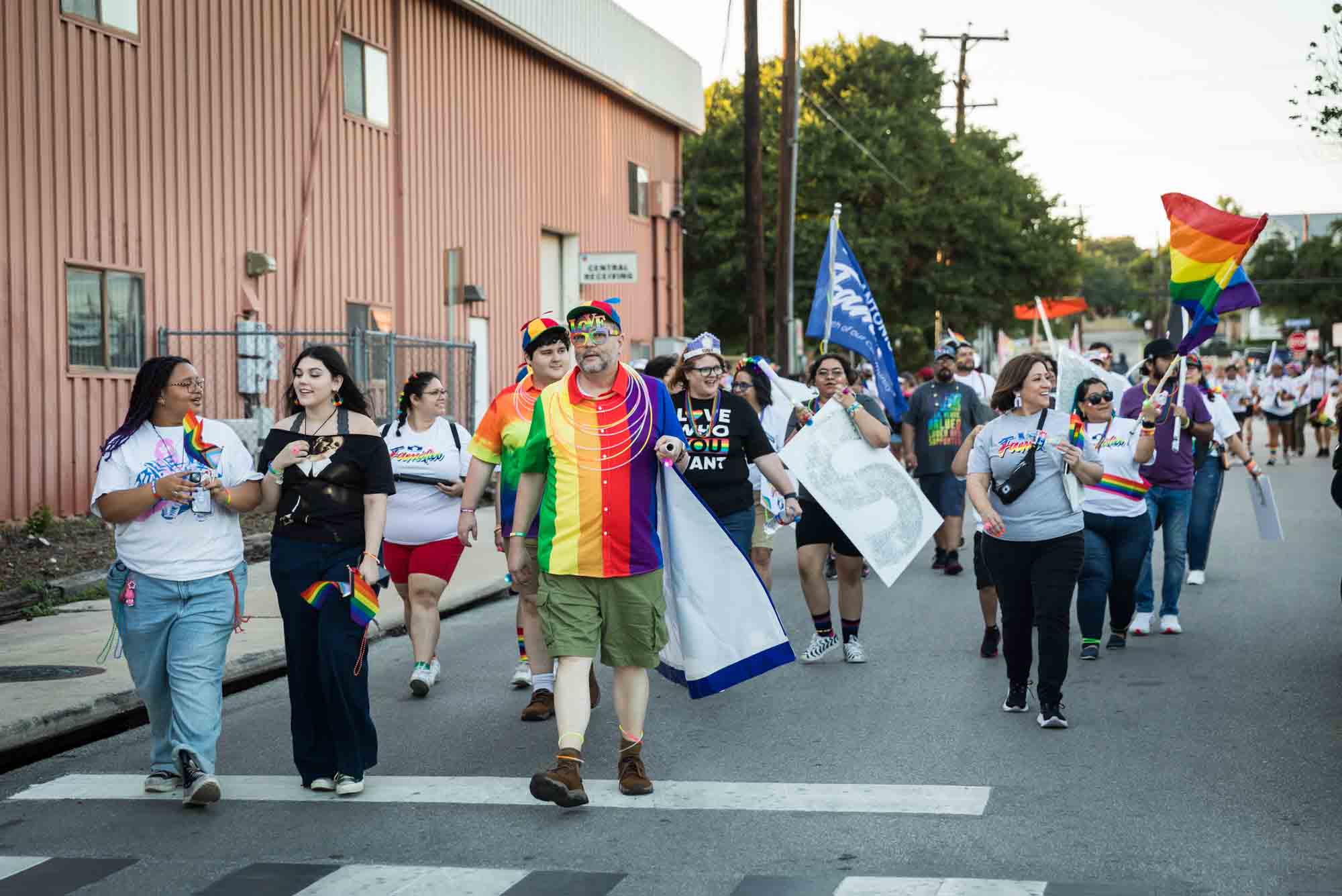 San Antonio gay pride parade photos of a group of people walking down street before parade begins