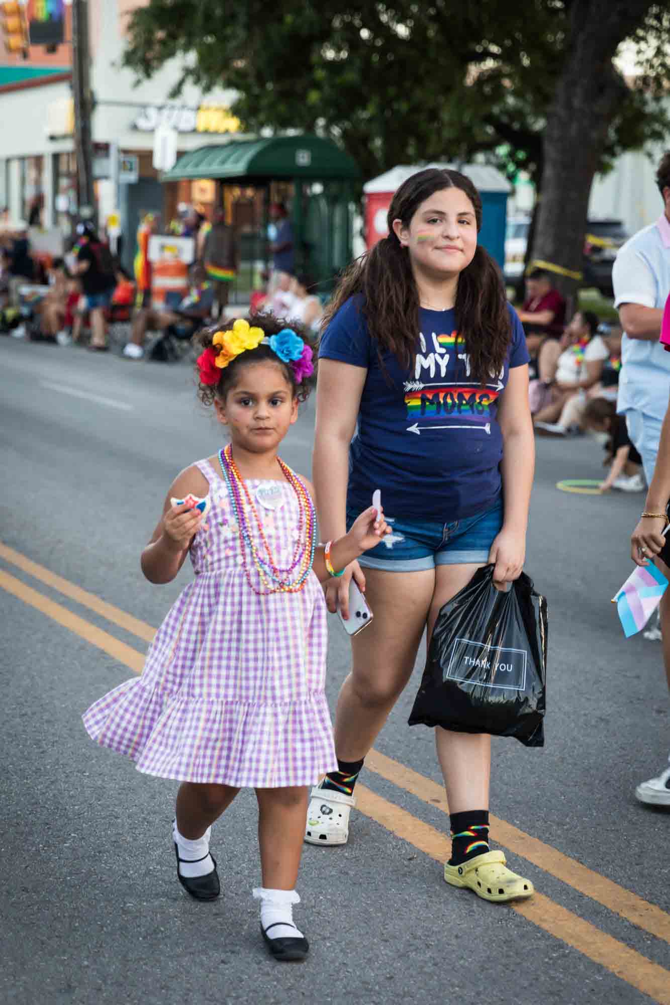 San Antonio gay pride parade photos of two young girls walking int eh street