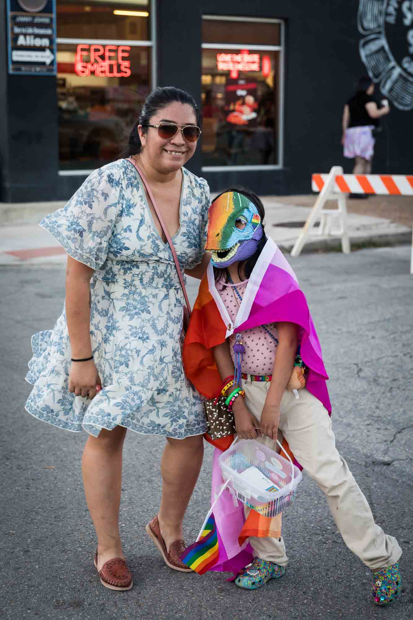 San Antonio gay pride parade photos of mother and daughter with hand-painted dinosaur mask