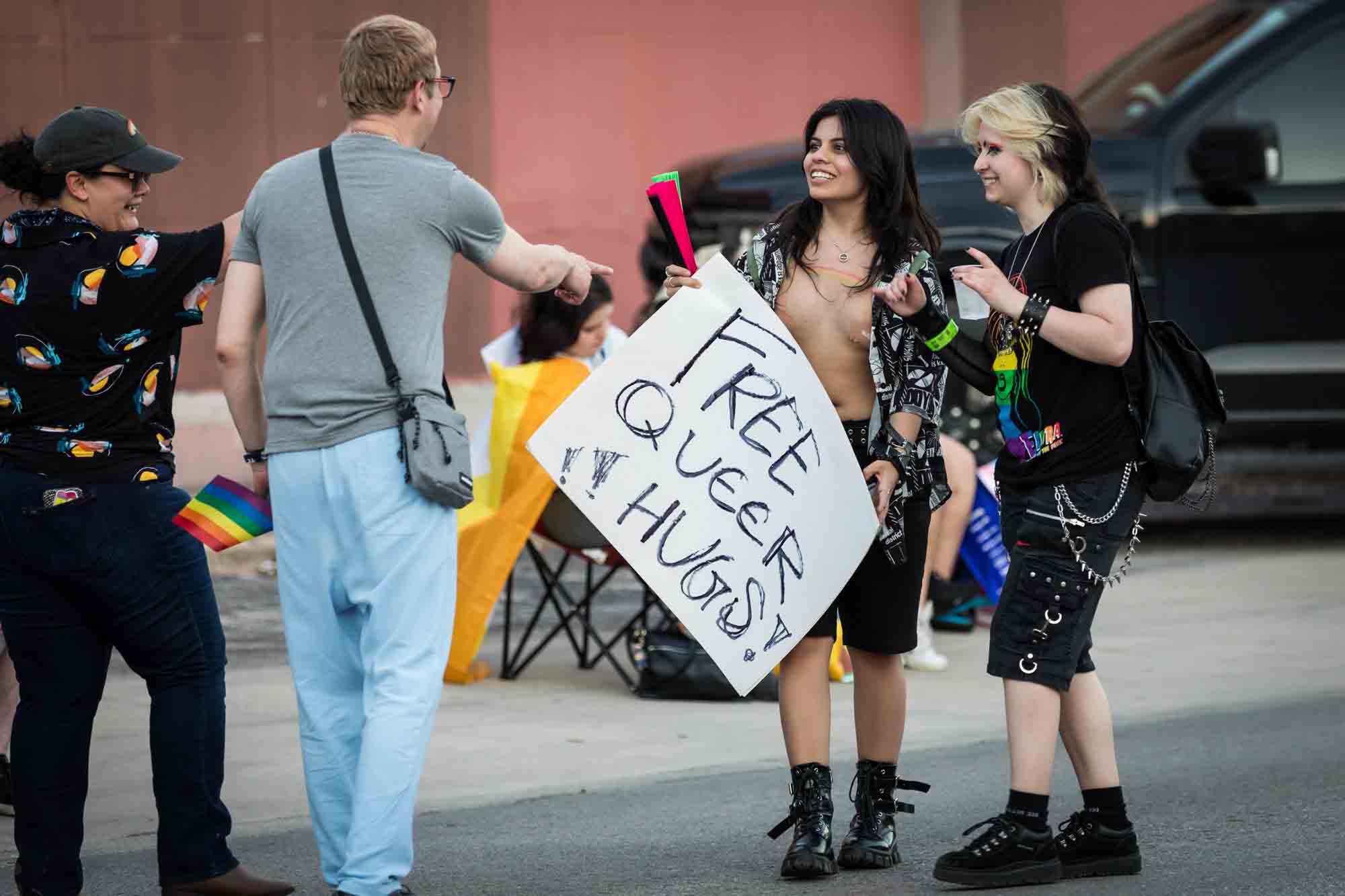 San Antonio gay pride parade photos of two people offering a group of people free queer hugs