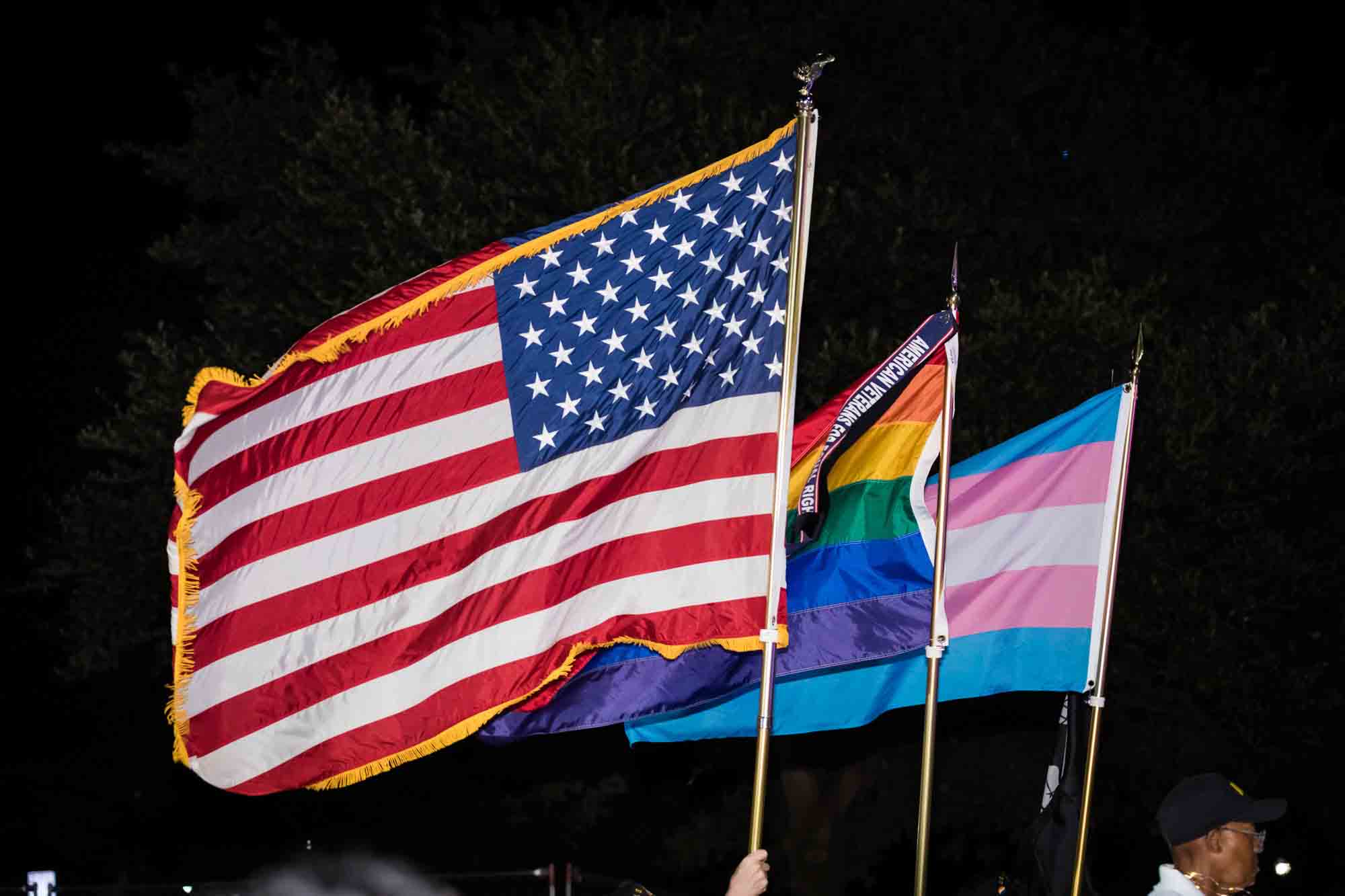 American flag and gay pride flags waving during parade