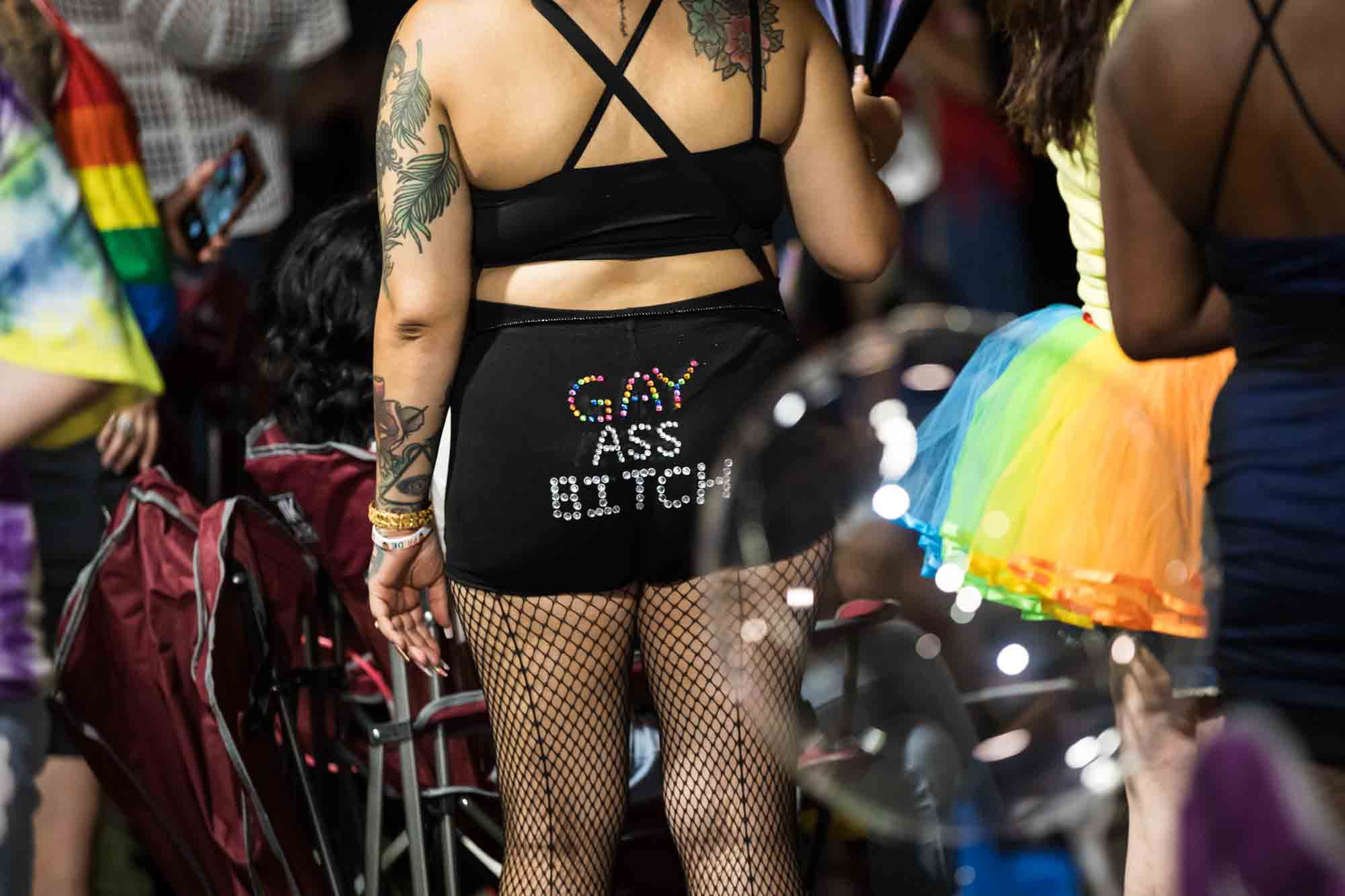 Close up of person wearing gay ass bitch sequined pants