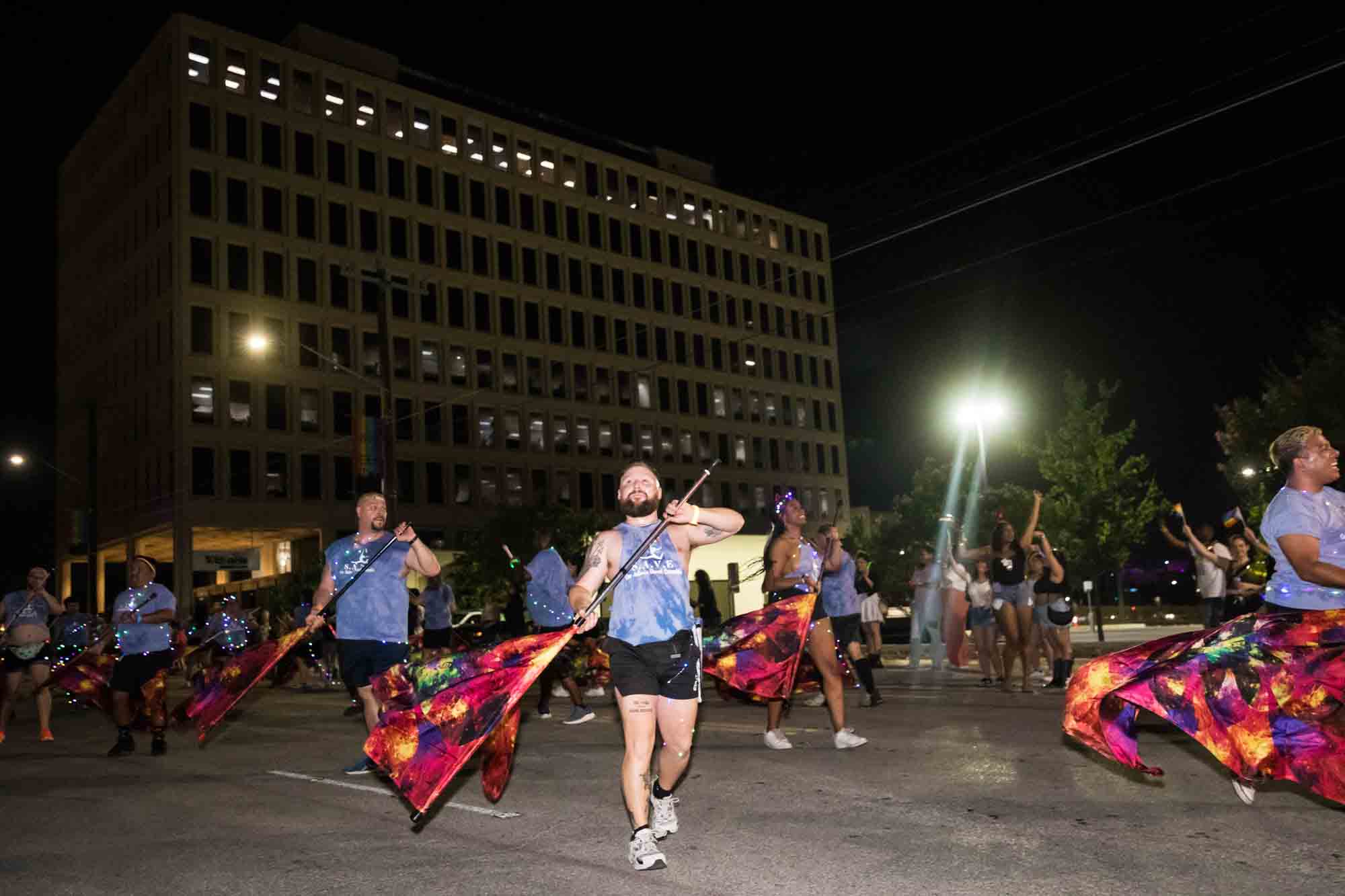 San Antonio gay pride parade photos of dancers waving flags in parade