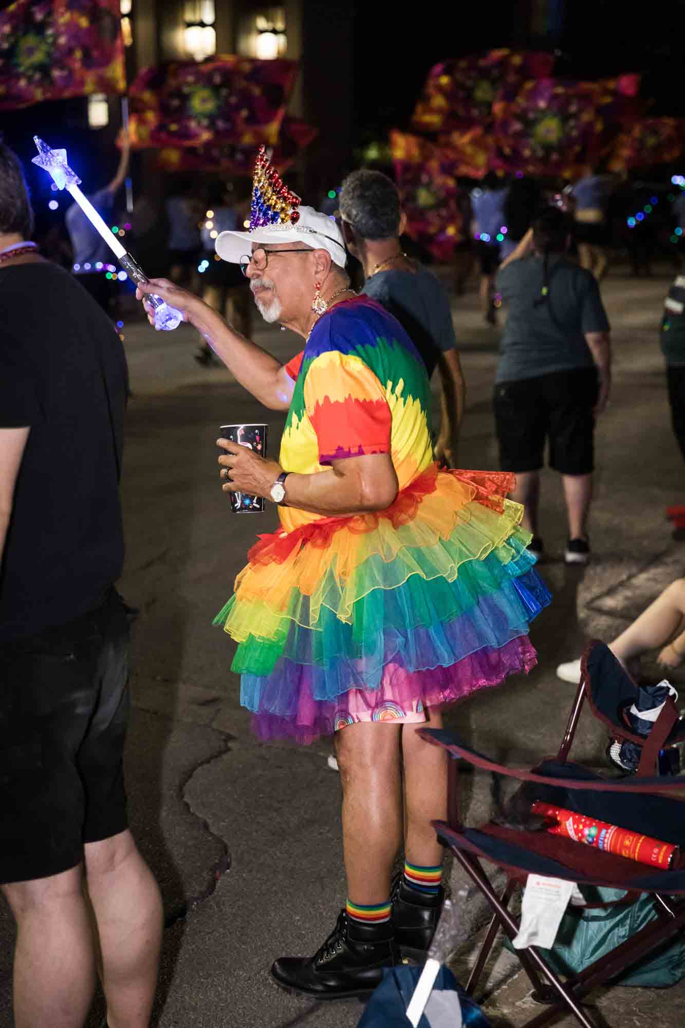 San Antonio gay pride parade photos of man dressed in rainbow outfit cheering on parade